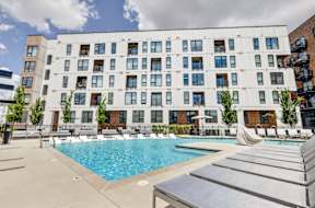 A large white building with a pool in front.