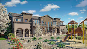 A large, multi-story residential building with a playground in front.