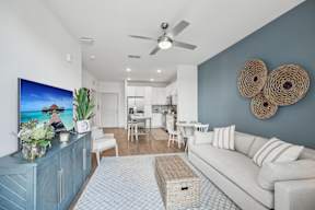 A living room with a flat screen TV on the wall.