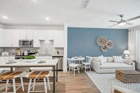 A modern kitchen with a dining table and chairs.