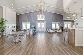 a living room with a table and chairs and a chandelier