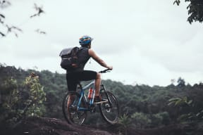 a man riding a bike on top of a hill