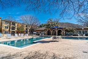 a swimming pool with a house in the background