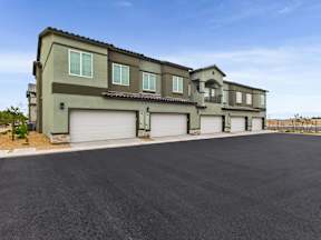 A modern two-story house with a large driveway in front.