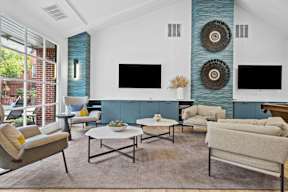 a living room with couches and chairs and a television