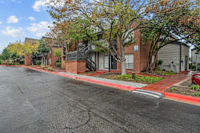 an empty street in front of a row of houses on a street