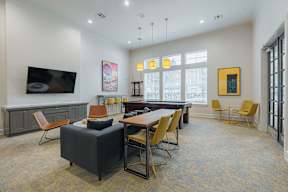 a lounge area with a table and chairs and a television