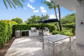 a patio with a table and chairs and an umbrella