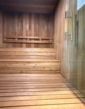 A wooden staircase with a glass door at the top.