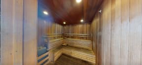 A row of wooden benches are lined up in a sauna.