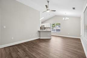 A room with a ceiling fan and light fixture.