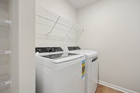 A white washing machine and dryer in a small laundry room.