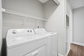 A white washing machine and dryer in a laundry room.
