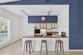 A kitchen with a white counter and a white fridge.