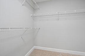 Empty room with white walls and a carpeted floor.
