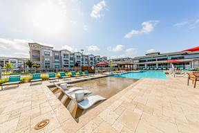 A sunny day at the poolside with a clear blue sky.