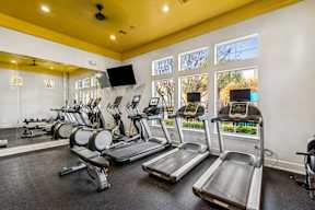 A gym with treadmills and exercise bikes.