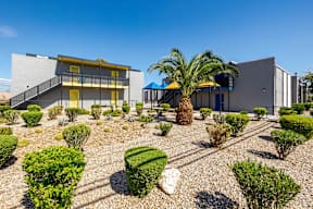 a house with a courtyard with palm trees and other buildings