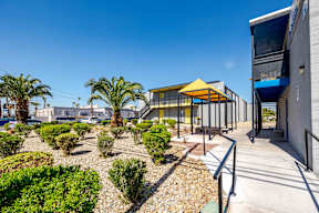 a building with a courtyard with palm trees