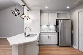 a kitchen with white cabinets and a white counter top