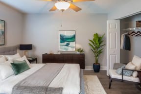 a bedroom with a large bed and a ceiling fan