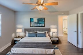 a bedroom with a bed and a ceiling fan