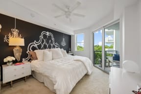 a bedroom with a large bed and a ceiling fan