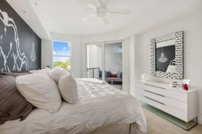 a bedroom with a large bed and a white dresser