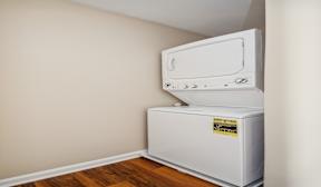 A wall-mounted air conditioner unit sits in a corner of a room.