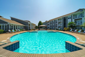 a large swimming pool in front of an apartment building