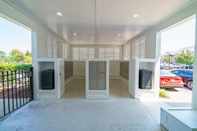 a view of the front porch of a home with mailboxes and a parking lot