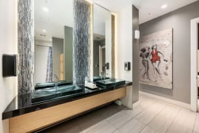 a bathroom with two sinks and a large mirror
