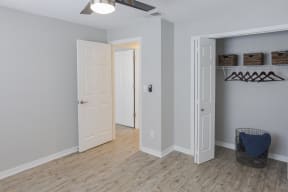 a renovated living room with a closet and a wood floor