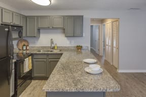 an open kitchen with granite counter tops and stainless steel appliances