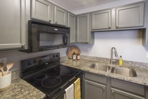 a kitchen with stainless steel appliances and granite counter tops