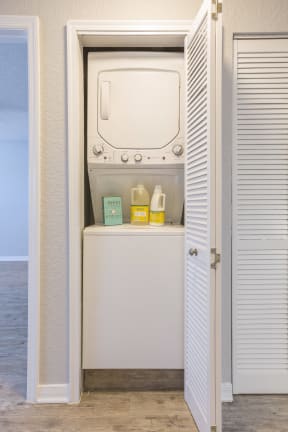 a washer and dryer in a closet next to the ocean