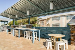 a patio with tables and chairs and a pergola