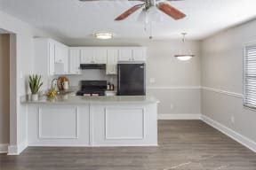a kitchen with white cabinets and a counter top