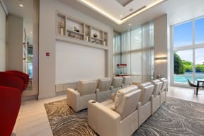 a conference room with white chairs and a projector screen
