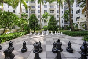 a game of chess in the courtyard of an apartment building