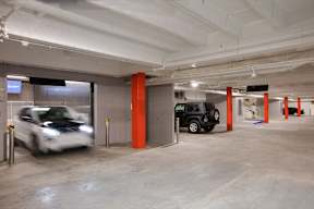 A white car is entering a parking garage.