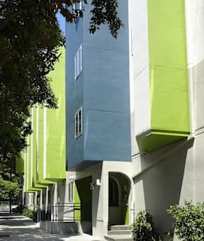 A building with a blue and green exterior is shown.