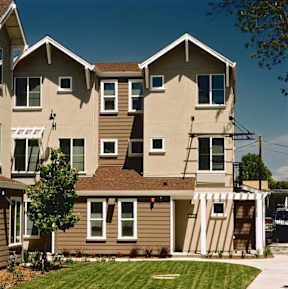 A large two story house with a brown and beige exterior.