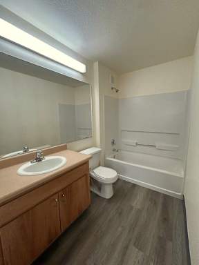 A bathroom with a toilet, sink, and bathtub.