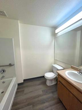A bathroom with a toilet, sink, and bathtub.