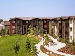 Apartment complex with a green lawn in front.