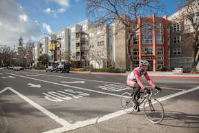 A person riding a bicycle in a bike lane.