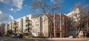 A street view of a building with a car parked in front.