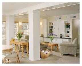 A dining room with a table and chairs.
