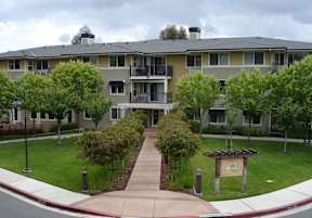 Apartment complex with a sign in front of it.
